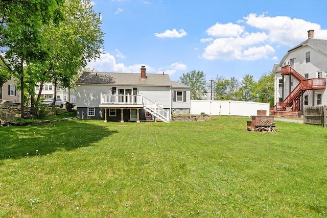 16 Elm St, Leominster, MA 01453 - back of property featuring stairway, a wooden deck, and a chimney
