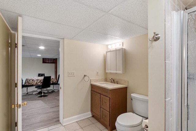 16 Elm St, Leominster, MA 01453 - full bath featuring toilet, vanity, a paneled ceiling, connected bathroom, and tile patterned flooring