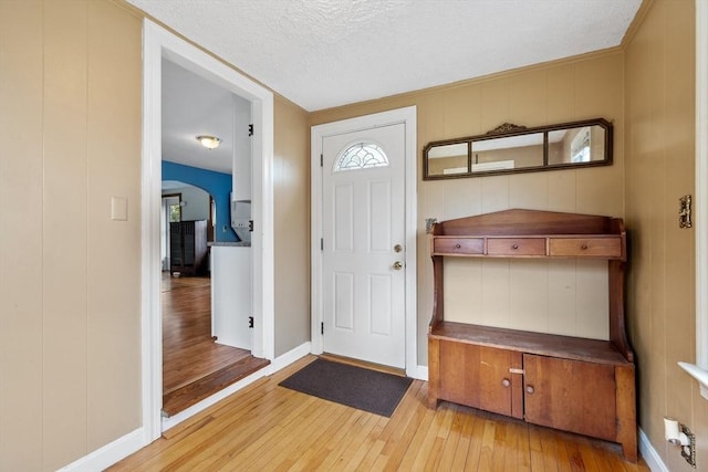 16 Elm St, Leominster, MA 01453 - entryway with hardwood / wood-style flooring, a textured ceiling, arched walkways, and baseboards