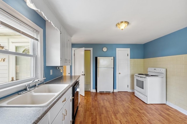 16 Elm St, Leominster, MA 01453 - kitchen featuring white appliances, a sink, white cabinets, light wood finished floors, and tile walls