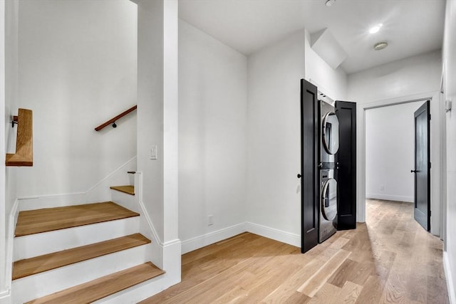 116 Moore St Unit 305, Boston, MA 02128 - staircase with stacked washer / dryer, wood finished floors, and baseboards
