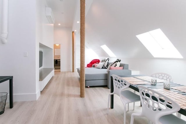 interior space with a skylight, baseboards, a wall mounted air conditioner, and wood finished floors