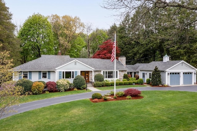 single story home with asphalt driveway, a front lawn, a garage, and a chimney