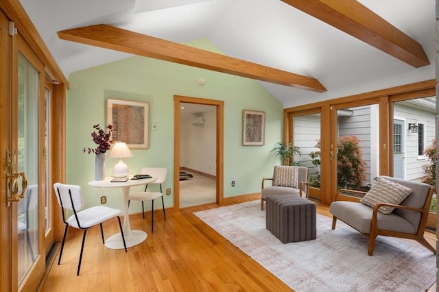 living area featuring light wood-type flooring and baseboards