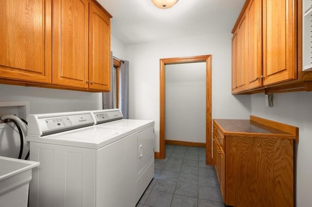 clothes washing area featuring cabinet space, independent washer and dryer, tile patterned flooring, and baseboards