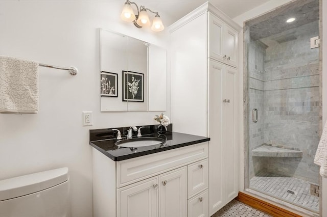 full bath with a shower stall, toilet, and vanity