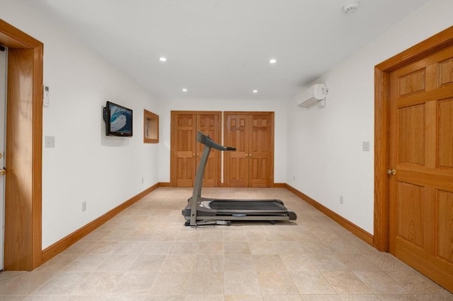workout area featuring recessed lighting, baseboards, and a wall mounted air conditioner