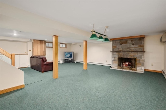 unfurnished living room with carpet floors, a stone fireplace, a baseboard radiator, and baseboards