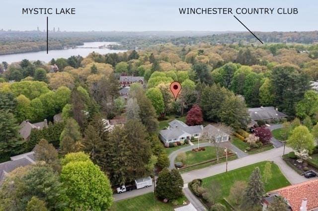 bird's eye view of a nearby body of water and a heavily wooded area