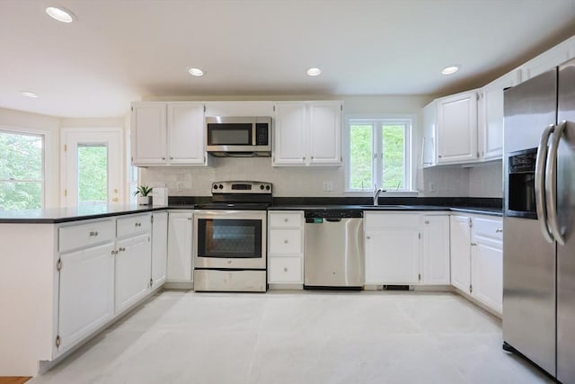 37 Annetta Rd, Ashland, MA 01721 - kitchen featuring appliances with stainless steel finishes, a sink, tasteful backsplash, a peninsula, and recessed lighting