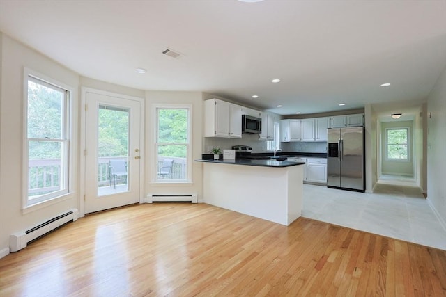37 Annetta Rd, Ashland, MA 01721 - kitchen with appliances with stainless steel finishes, a baseboard heating unit, dark countertops, plenty of natural light, and recessed lighting