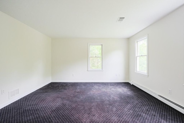 37 Annetta Rd, Ashland, MA 01721 - empty room with a baseboard heating unit, dark colored carpet, and baseboards