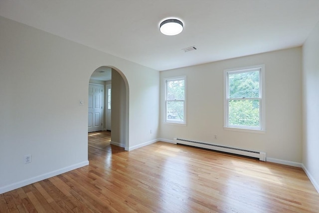 37 Annetta Rd, Ashland, MA 01721 - spare room featuring a baseboard radiator, arched walkways, light wood finished floors, and baseboards