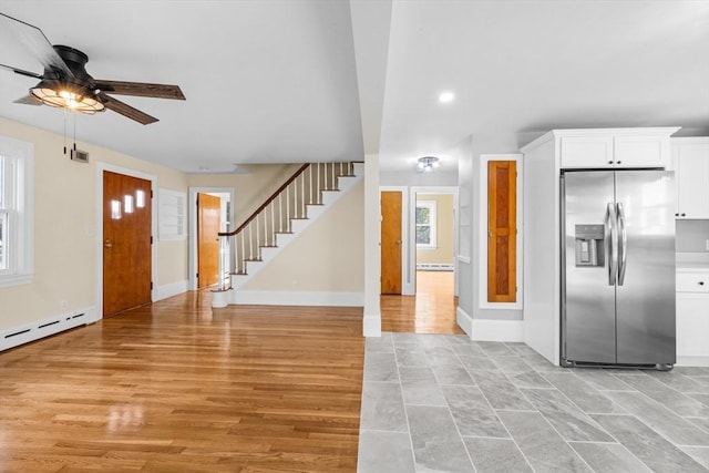 foyer featuring a ceiling fan, stairway, recessed lighting, baseboards, and baseboard heating