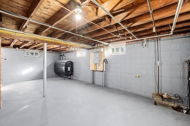 basement featuring oil tank and electric panel