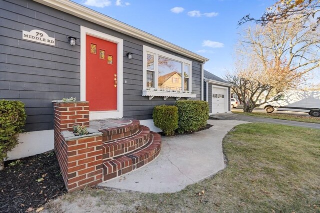 property entrance with driveway and an attached garage