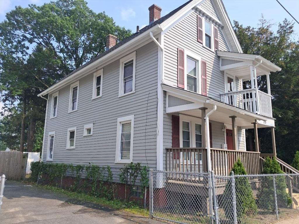 25 Clifton Ave, Springfield, MA 01105 - view of property exterior with covered porch, a chimney, a fenced front yard, and a balcony