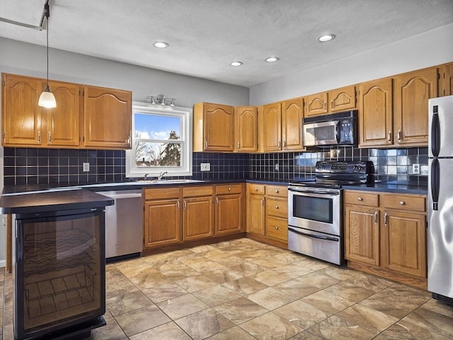 kitchen featuring brown cabinets, dark countertops, and stainless steel appliances