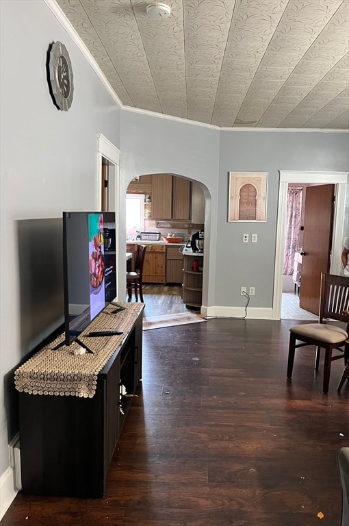 living room featuring dark hardwood / wood-style flooring and ornamental molding