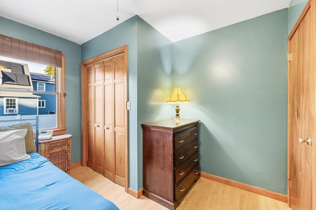 bedroom featuring a closet and light wood-type flooring