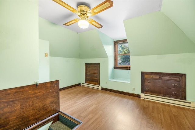 bonus room featuring ceiling fan, light hardwood / wood-style floors, lofted ceiling, and baseboard heating