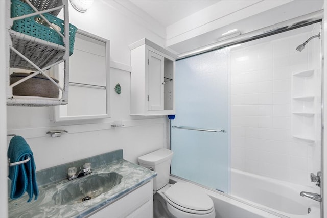 full bathroom featuring shower / bath combination with glass door, vanity, and toilet