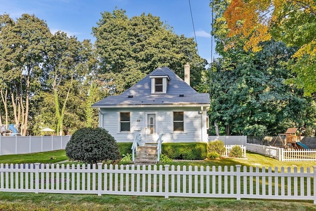 view of front facade with a playground and a front lawn