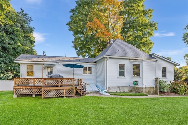 back of property featuring a yard and a deck