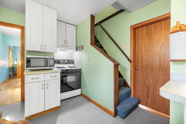 kitchen featuring white cabinets and gas stove