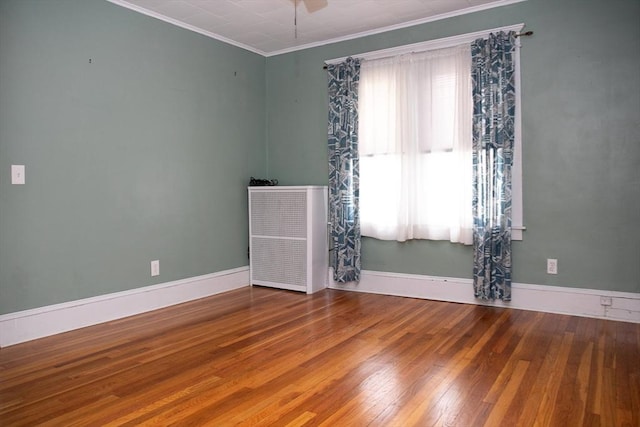 unfurnished room with crown molding, hardwood / wood-style flooring, and ceiling fan