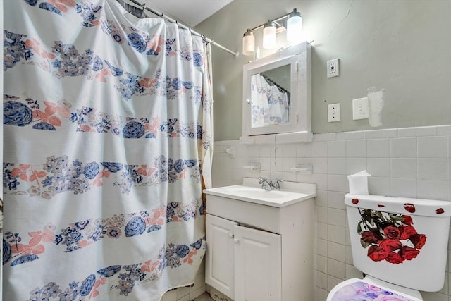 bathroom featuring vanity, tile walls, curtained shower, and toilet