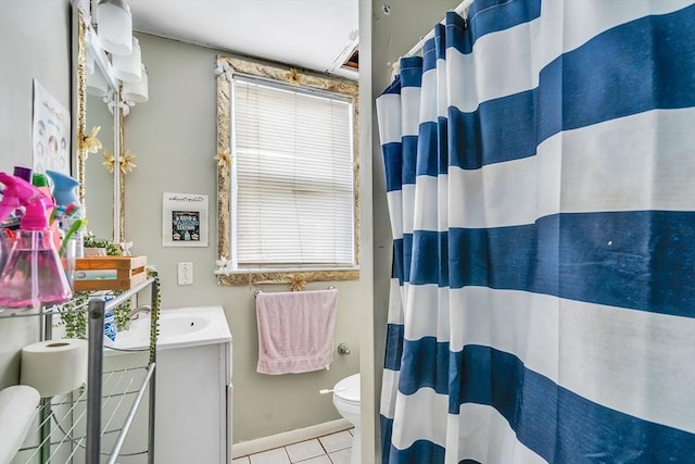 bathroom featuring vanity, plenty of natural light, tile patterned floors, and toilet