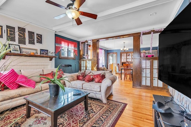 living room featuring beamed ceiling, crown molding, ceiling fan with notable chandelier, and hardwood / wood-style floors