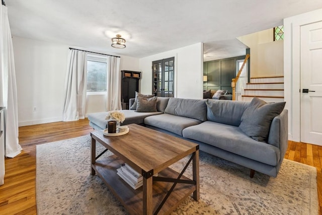 17 Atwood Ave, Millbury, MA 01527 - living room with stairway, wood finished floors, and baseboards