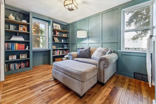 17 Atwood Ave, Millbury, MA 01527 - sitting room featuring a decorative wall, hardwood / wood-style floors, and built in features