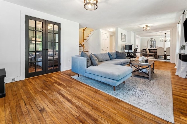 17 Atwood Ave, Millbury, MA 01527 - living area with stairway, french doors, wood finished floors, and a chandelier