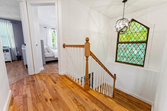 17 Atwood Ave, Millbury, MA 01527 - stairs with wood finished floors, a chandelier, and baseboards