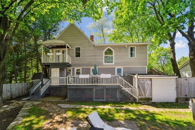 17 Atwood Ave, Millbury, MA 01527 - back of property featuring a balcony, a fenced backyard, stairway, and a chimney