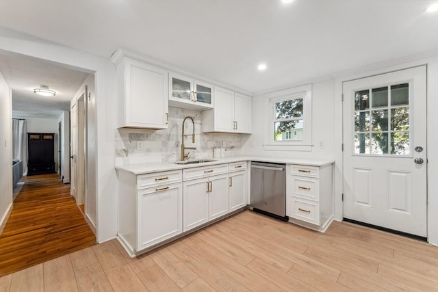 17 Atwood Ave, Millbury, MA 01527 - kitchen featuring stainless steel dishwasher, a sink, light countertops, white cabinetry, and light wood finished floors