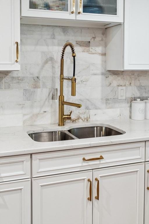 17 Atwood Ave, Millbury, MA 01527 - kitchen featuring a sink, white cabinets, backsplash, and glass insert cabinets