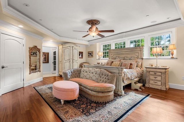 bedroom with ceiling fan, crown molding, multiple windows, and light wood-type flooring