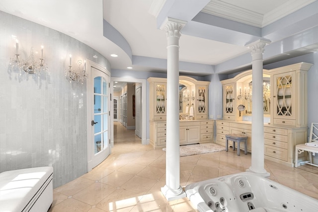 bathroom featuring tile patterned floors, a bathtub, ornamental molding, decorative columns, and vanity