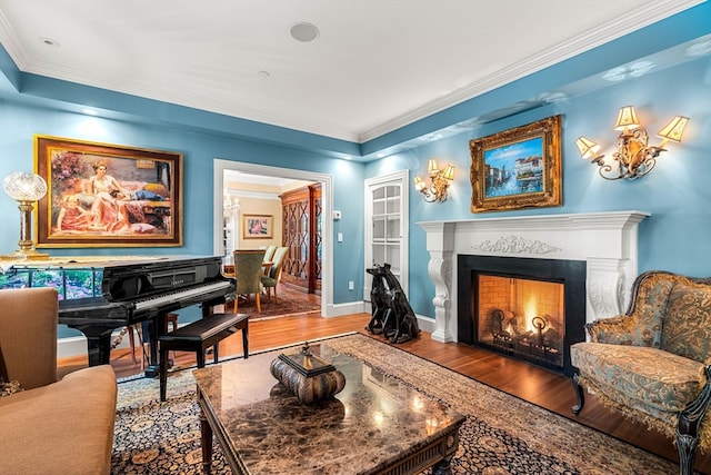 living area featuring crown molding and hardwood / wood-style floors