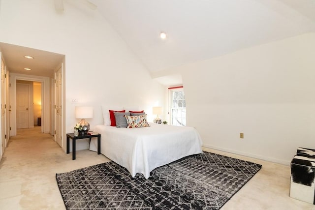 bedroom featuring high vaulted ceiling and light carpet