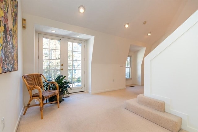 sitting room with french doors and light carpet