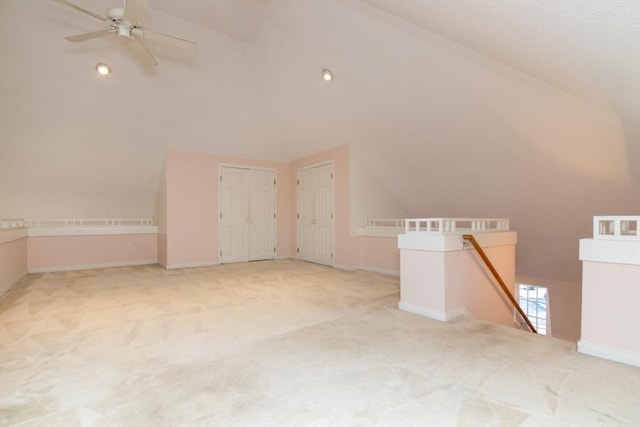 bonus room with lofted ceiling, light colored carpet, and ceiling fan