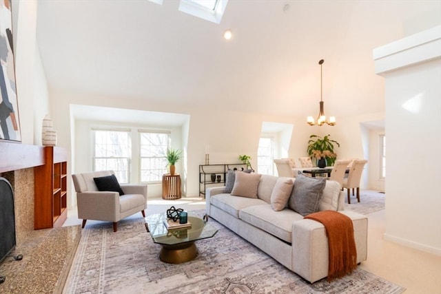 carpeted living room featuring a notable chandelier, a towering ceiling, and a high end fireplace