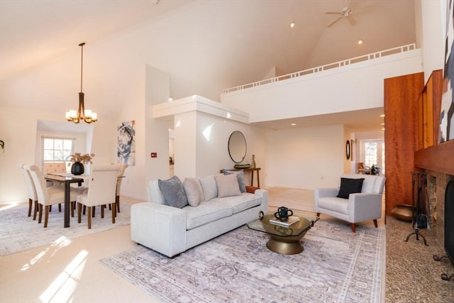 living room with a wealth of natural light, a notable chandelier, and high vaulted ceiling