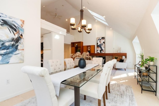 dining space with a skylight, high vaulted ceiling, light carpet, and a notable chandelier