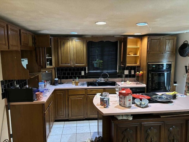 27 Hilton Ter, Boston, MA 02119 - kitchen featuring black oven, light countertops, and backsplash